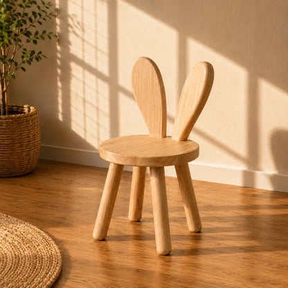 A light natural wood 12-compartment cubby shelf with a slanted top, shown against a warm beige wall with soft window shadow patterns and a matching wood floor.