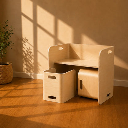 Light natural wood storage furniture set in a sunlit room, including a small shelf unit with side handles, a rectangular storage bin, and a cylindrical storage container, placed against a beige wall on a wood floor with window shadows.