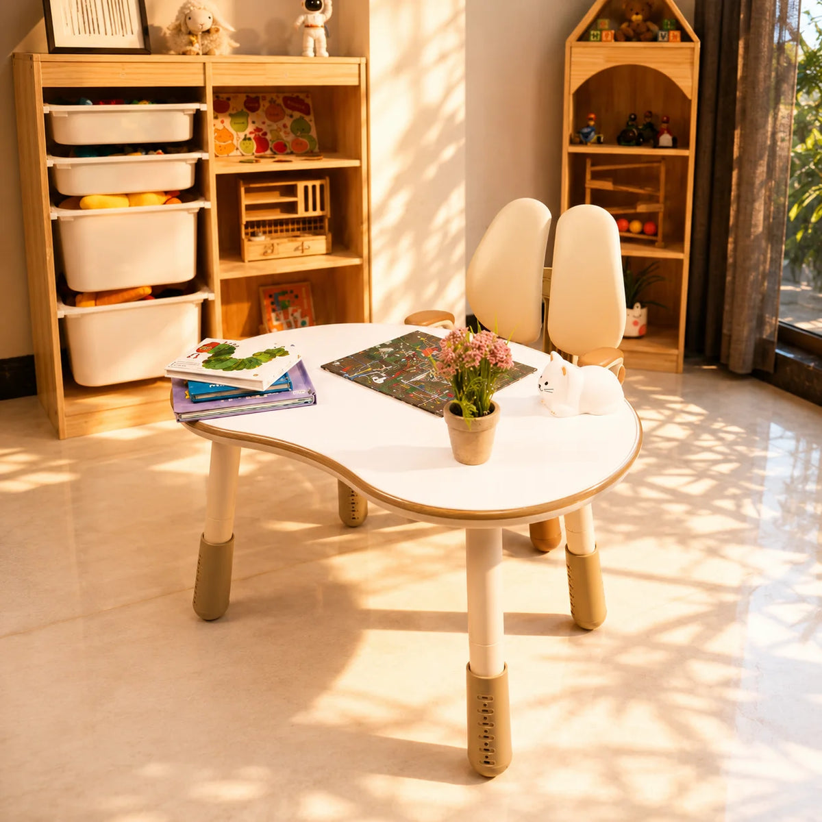 A light beige children's table and matching adjustable chair set in a bright, minimalist room with framed wall art and warm sunlight.