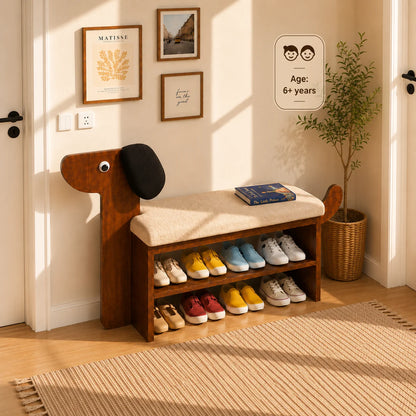 A wooden entryway bench with a dog-shaped head and a light beige cushion, styled in a warm, sunlit room. The bench has two open shelves underneath for shoes, with several shoes displayed.