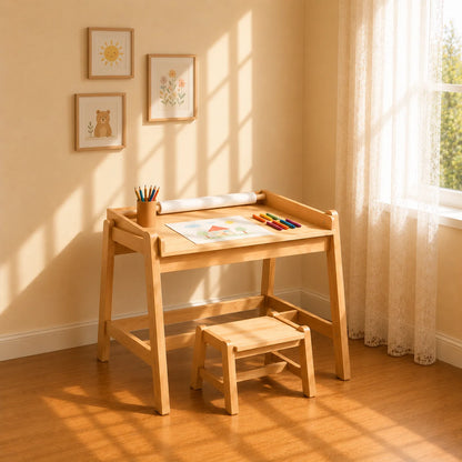 A light natural wood children's desk and matching stool set in a sunlit room with warm beige walls, framed animal prints, and a window with sheer curtains.