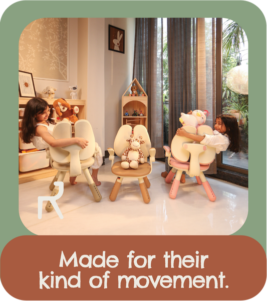 Three children sitting on small wooden chairs with plush toys, in a bright nursery or playroom. The image has a green border and a brown text banner at the bottom that reads, 'Made for their kind of movement.